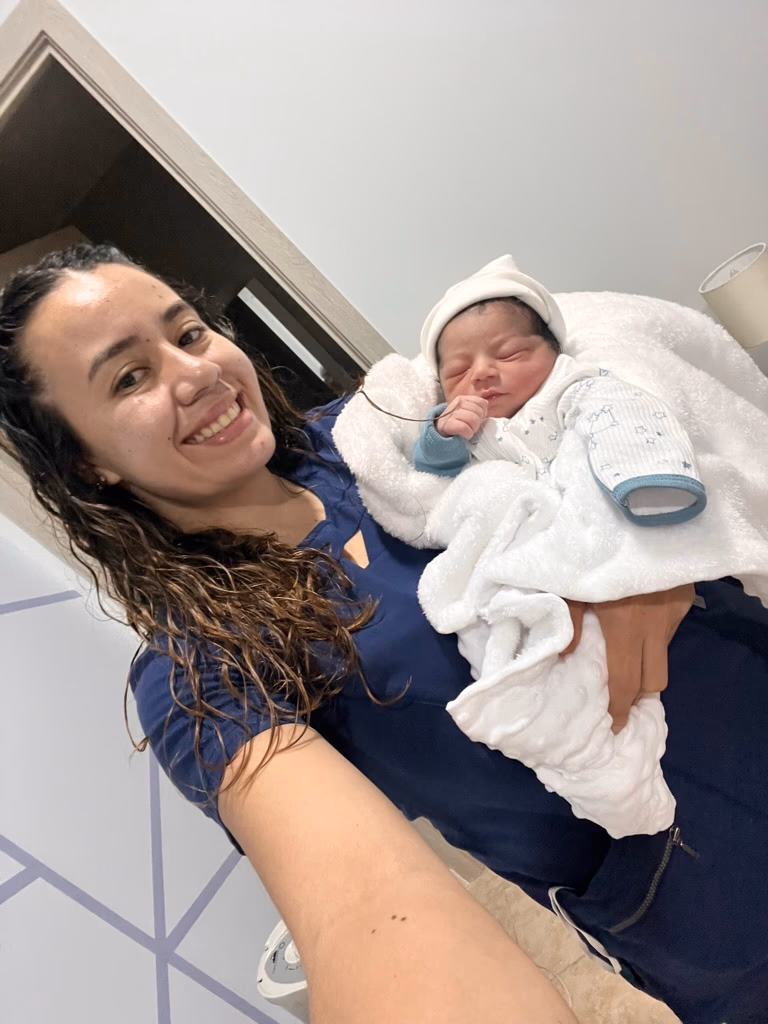 Pediatrician Guatemala Dr. Padilla with a newborn in her arms